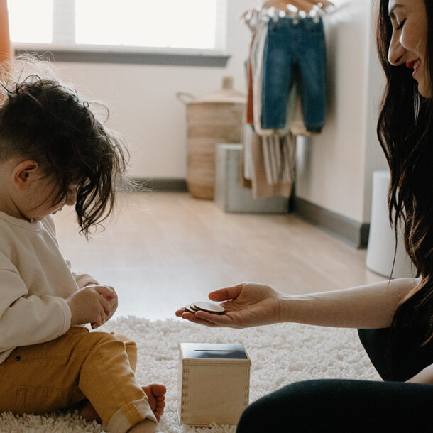 Mother and son playing in a child bedroom with wooden blocks