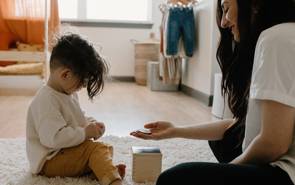 Mother and son playing in a child bedroom with wooden blocks