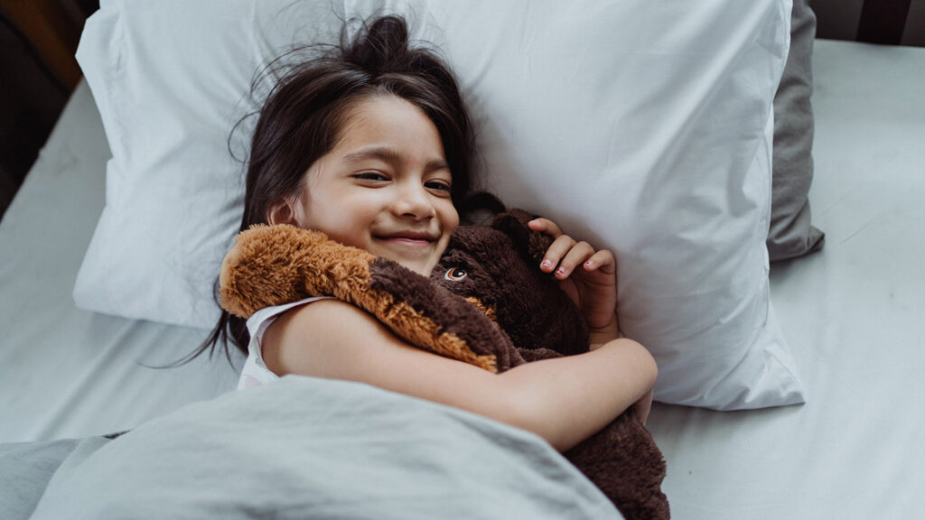 Mindfulness exercises for toddler girl and cuddly toy, practicing mindful breathing