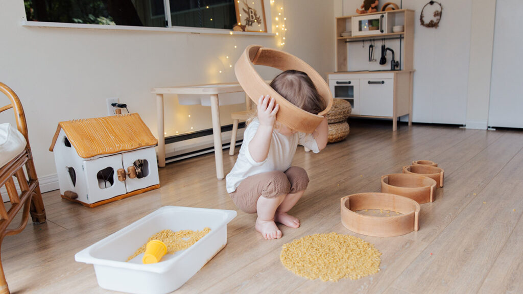 Child looking in sensory play bin