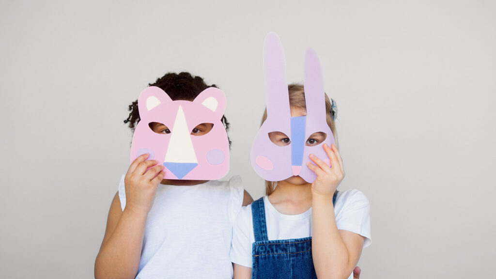 Two small girls sensory play with masks